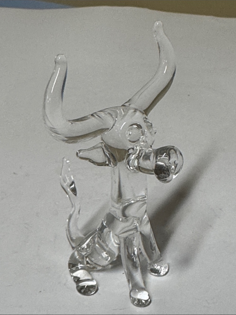 clear hand-blown glass figurine of a longhorn bull or cow with large curved horn